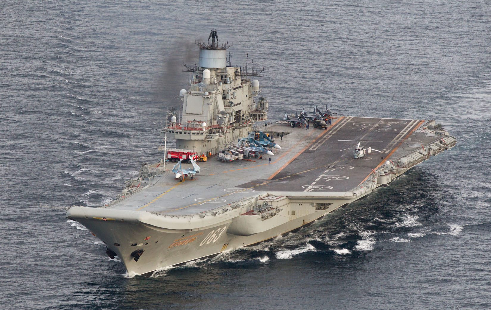 This October 17, 2016 Norwegian Armed Forces handout image shows the Russian aircraft carrier Admiral Kuznetsov passing the Norwegian island of Andoya in international waters on its way to the mediterranean. - The Admiral Kuznetsov aircraft carrier the nuclear powered  battleship Pyotr Velikiy and six other vessels were photographed by Norway' s Lockheed P-3 Orion surveillance aircraft. (Photo by STR / forsvaret / AFP) / RESTRICTED TO EDITORIAL USE - MANDATORY CREDIT "AFP PHOTO / Forsvaret " - NO MARKETING - NO ADVERTISING CAMPAIGNS - DISTRIBUTED AS A SERVICE TO CLIENTS
